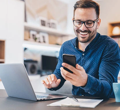 Young businessman working at home using laptop